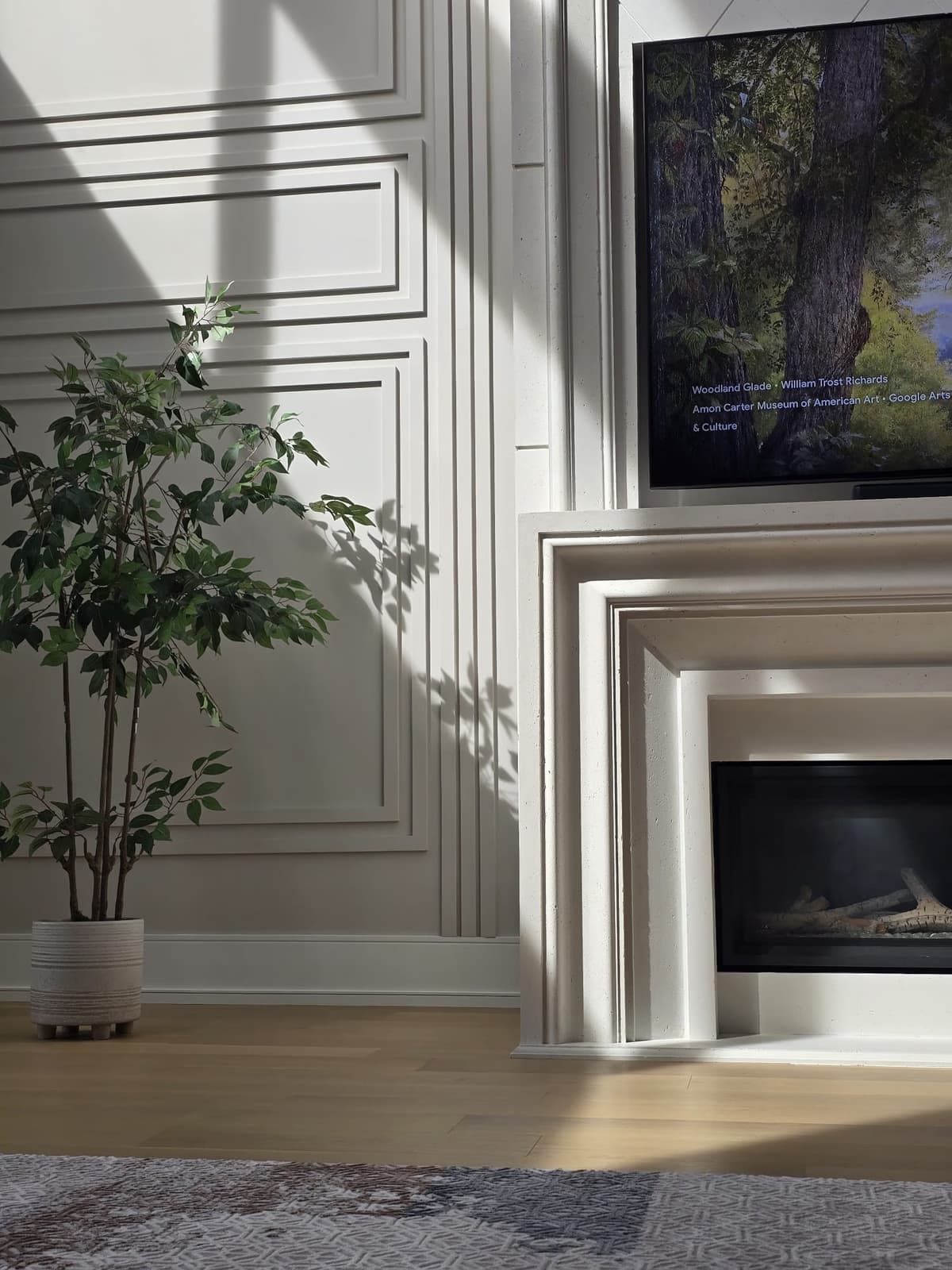 Fireplace detail with wainscoting and natural light