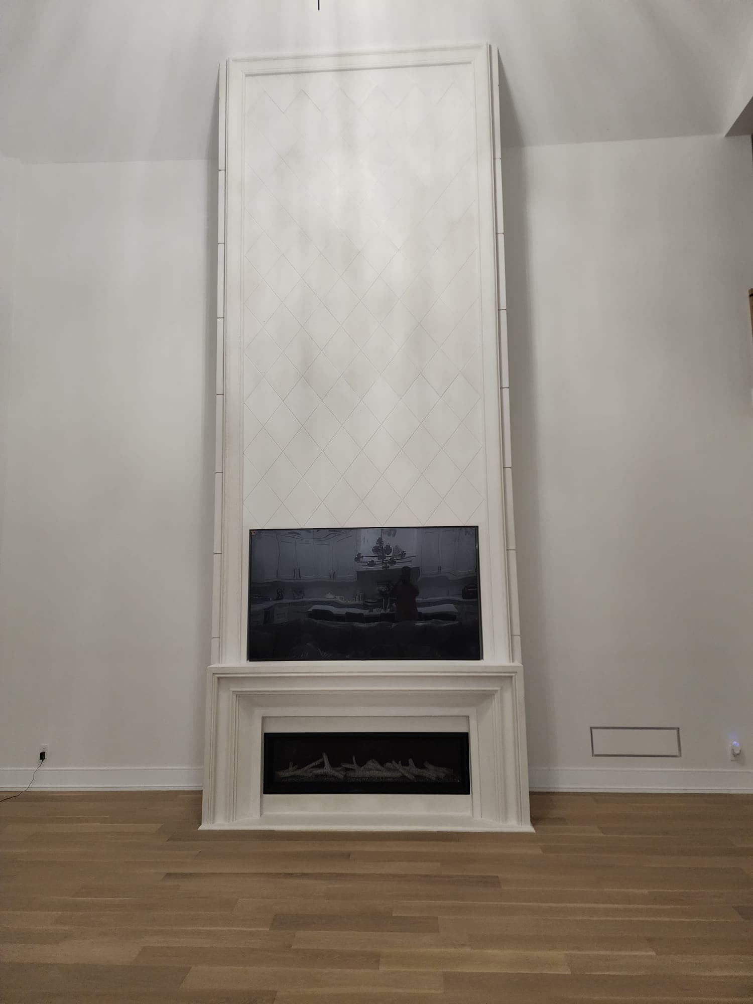 Full height fireplace with diamond pattern tile