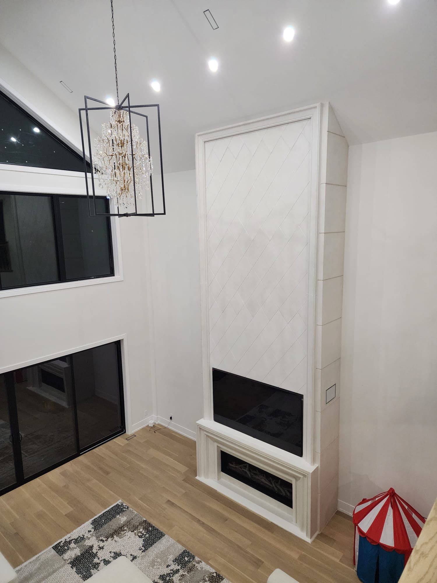 Custom tall fireplace with diamond tile surround